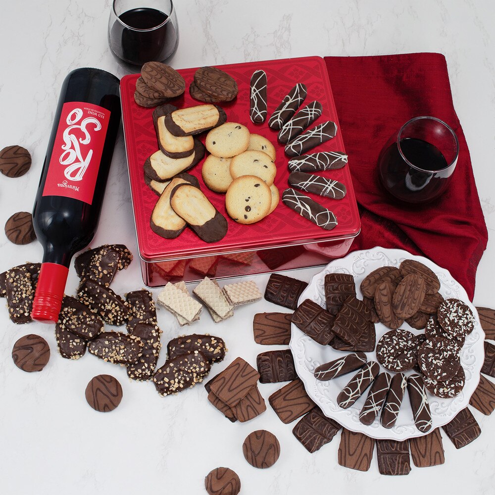 chocolate cookies in the box near red wine bottle